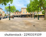Small photo of Saint-Tropez, France - June 14 2022: Sidewalk cafes and shops at the spacious tree lined Place des Lices town square and park in the historic center of Saint-Tropez, France, French Riviera.