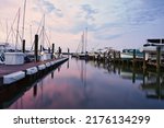 Boats in the marina at sunset. A sky in pastels over Annapolis on the Chesapeake Bay in the state of Maryland, USA.                               