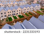 Aerial view of rows of new build modular terraced houses in the UK with characterless design for first time buyers