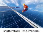 Small photo of Man is working on cleaning solar panels. repair, maintenance, reuse, and periodical maintenance of solar panels, green power clean energy Earth conservation, and environment concept