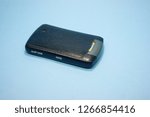 Small photo of Indonesia - December 2018 : Blackberry Curve 8310 grey color back view isolated on blue background