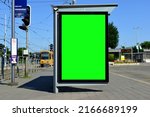 Bus shelter and bus stop in urban bus and tram terminal area. light traffic. glass and aluminum structure. poster ad display glass and light box. banner and copy space. streetscape. mockup base