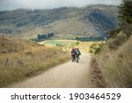 Small photo of Three people cycling the Otago Central Rail Trail among mountain ranges between Waipiata and Middlemarch, South Island, New Zealand