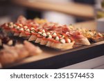 Snacks for the holiday, catering. Various light snacks. Catering plate. Assortment of sandwiches on the buffet table. meat, fish, nuts, cheese, vegetable canapes ofcelebration of important event. 