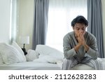 Small photo of Asian young man feel angry girlfriend having conflict domestic problem. New marriage man and woman feel heartbroken for quarrel conflict while sit on bed in bedroom. Family problem-separation concept.