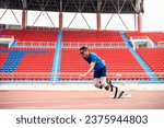 Small photo of Asian para-athletes disabled with prosthetic blades running at stadium. Attractive amputee male runner exercise and practicing workout for Paralympics competition regardless of physical limitations.
