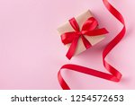 gift box and red ribbon on pink ... | Shutterstock . vector #1254572653