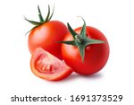 Two whole and cut wedge of fresh, red tomato isolated on white background. Clipping path. Full depth of field.