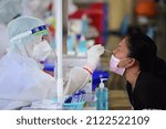 Small photo of Thailand : February 13, 2022 - Public health workers wearing PPE are providing Rapid antigen test services to people, using Kheha Thung Song Hong Wittaya School 2 Bangkok as an ad hoc service point.