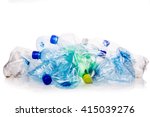 Mineral water and fizzy drinks bottles crushed and crumpled against white isolated background