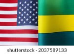 Small photo of fragments of the national flags of the United States and the Gabonese Republic in close-up