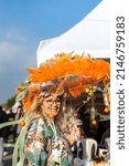 Small photo of Smiling beautiful woman with florid umbrella on traditional Orange Blossom carnival in the city of Adana of Turkey country. 03.25.2022