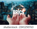 Small photo of two hands embracing globe icon New currency concept of 'BRICS', cooperation of 5 superpowers begins Enter into a cooperation agreement on the use of a new currency for international trade.