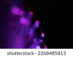 Small photo of Blur neon light. Lens flare overlay. Bokeh fluorescent flash gleam. Defocused blue purple color flecks on dark black abstract background.