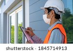 Small photo of Inspectors or engineers are wearing an anti-virus mask and checking the building structure and the requirements of the wall paint. After the renovation is completed