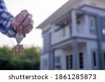 Homeowner holding a new house key from a broker after agreeing to buy a mortgage-home investment. Concept buying a house , a new home.