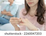 Small photo of Divorce. Woman remove married ring. Couples desperate and disappointed after marriage. Husband wife sad, upset and frustrated after quarrels conflict. distrust, love problems, betrayals, family, lover