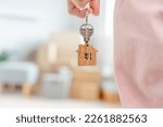 Small photo of Moving house, relocation. Woman hold key house keychain in new apartment. move in new home. Buy or rent real estate. flat tenancy, leasehold property, new landlord, dwelling, loan, mortgage.