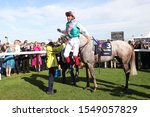 Small photo of DONCASTER RACECOURSE, STH YORKSHIRE, UK : 14 SEPTEMBER 2019 : Frankie Dettori executes a Flying Dismount from Logician after winning the 2019 running of the Group 1 St Leger at Doncaster Races