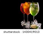 alcohol cocktail set on a black background with fresh summer fruits 