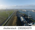 Discover the fascinating connection between wind energy and maritime trade with an unforgettable aerial footage of Eemshaven port, showcasing the harmonious coexistence of wind turbines, ships, and
