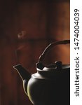 Small photo of Silhouette of a boiling kettle. Steam comes out of the tea spout. The smoke from the chimney. A powerful jet of steam. Blow off steam!