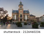 Small photo of Brussels, BELGIUM - October 8, 2021: Twon Hall of Anderlecht at sunset. Families and people enjoying the sunset at town hall square