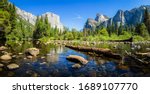 Scenic panoramic view of famous Yosemite Valley with El Capitan rock climbing summit and idyllic Merced river on a beautiful sunny day with blue sky in summer, Yosemite National Park, California, USA