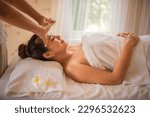 Small photo of Side view of beautiful asian woman's face in close up shot is serene and relaxed as the massage continues allowing her to fully surrender to the experience.