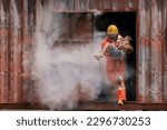 Small photo of The firefighter's heroic act of carrying a child out of a smoke filled and dangerous place shows their dedication and bravery towards their duty.