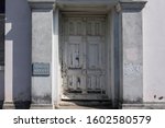 Small photo of The main entrance to an abandoned bank building, with a "Cheque accounts" sign on a pillar beside the door. Tokomaru Bay, East Cape, New Zealand.