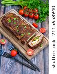 Small photo of Home made baked delicious German meatloaf (Falscher Hase or Hackbraten) is a traditional pork and beef meat loaf bound with boiled eggs and cucumbers