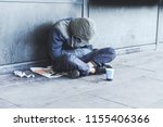 Homeless Man Sitting On The...