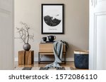 Modern scandinavian living room interior with black mock up poster frame, design commode,  leaf in vase, black rattan basket, books and elegant accessories. Template. Stylish home decor. 