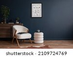 Small photo of Elegant modern living room interior design with fluffy armchair, pouf, wooden commode, mock up poster frame and modern home accessories. Blue wall. Template. Copy space.