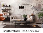 The stylish compostion at living room interior with design gray sofa, armchair, black coffee table, lamp and elegant personal accessories. Loft and industrial interior. Template. 