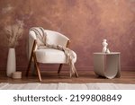 Small photo of Minimalist composition of elegant and outstanding space with boucle armchair, modern pouf, design coffee table, vase with dried flowers and elegant accessories. Home decor. Template.