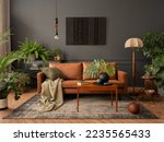 Interior design of living room interior with mock up poster frame, brown sofa, plants, wooden coffee table, lamp, ball, stylish rug, plaid, pillows and personal accessories. Home decor. Template. 