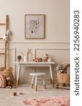 Small photo of Warm and cozy kids room interior with mock up poster frame, beige wall with stucco, white desk, stool, pillows, plush animal toys, garland on the wall and personal accessories. Home decor. Template.