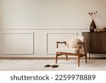 Small photo of Aesthetic composition of living room interior with copy space, boucle armchair, vase with dried flowers, round pillow, wooden sideboard, beige rug and personal accessories. Home decor. Template.