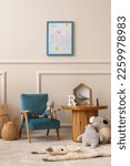 Small photo of Interior design of kids room with mock up poster frame, round wooden table, blue armchair, plush toys, animal rug, wooden blockers, wicker basket and personal accessories. Home decor. Template.