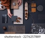 Small photo of Elegant flat lay composition in grey and black color palette with textile and paint samples, lamella panels and tiles. Architect and interior designer moodboard. Top view. Copy space.