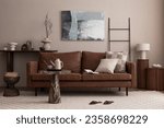 Small photo of Interior design of cozy living room interior with mock up poster frame, brown sofa, patterned pillow, plaid, slippers, round coffee table, beige pitcher and personal accessories. Home decor. Template.