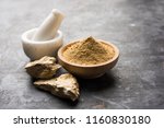 Small photo of Fuller'S Earth Clay OR Multani mitti in a bowl along with raw stones and mortar