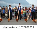 Small photo of Stans, Canton Nidwalden / Switzerland - August 01 2014: Event for the Rollout of the new Jet PC-24 from Pilatus Aircraft at Swiss National Day - a group of alphorn (alpenhorn) players