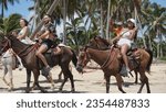 Small photo of Uvero Alto, Punta Cana, Dominican Republic, August, 29, 2023: excursion of tourists on horseback along a beautiful beach in Uvero Alto, Punta Cana, Dominican Republic