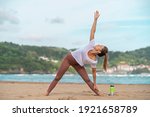 Brunette Woman Practicing Yoga...