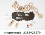 Small photo of Tell me more symbol. Concept words Tell me more on wooden notebook. Beautiful wooden background. Business and Tell me more concept. Copy space.