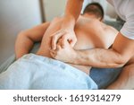 Wellness manual back massage for men. Relaxation of the lower back muscles by a male doctor in a private clinic. Photos for medical journals