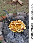 Small photo of Cooking apples outside in cast iron pan at Fort Frederica